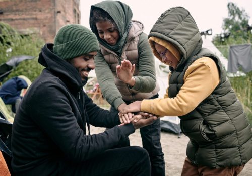man-playing-with-kids-in-refugee-camp.jpg